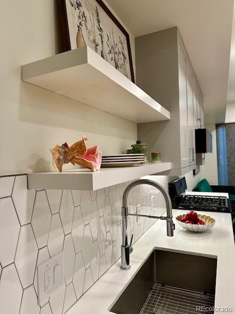 2876 W 53rd Ave Unit 305, Denver, CO 80221 - kitchen view of a sink, light countertops, and stainless steel range with gas stovetop