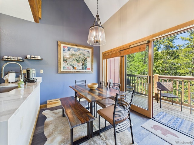 27 Lake Ridge Cir Unit 1842, Dillon, CO 80435 - dining area featuring wood finished floors, high vaulted ceiling, a chandelier, and baseboards