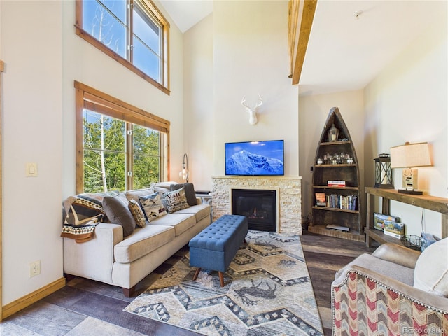 27 Lake Ridge Cir Unit 1842, Dillon, CO 80435 - living room featuring wood finished floors, a fireplace, baseboards, and a towering ceiling