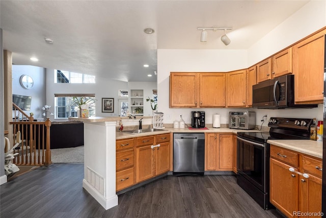 kitchen with a peninsula, light countertops, black electric range, stainless steel dishwasher, and a sink