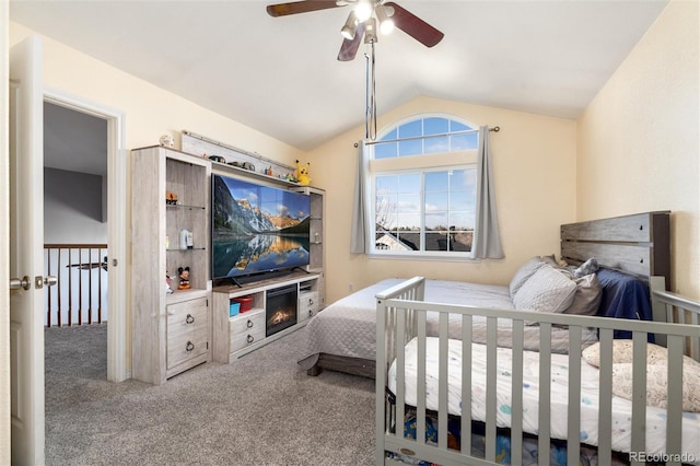 carpeted bedroom featuring vaulted ceiling and a ceiling fan