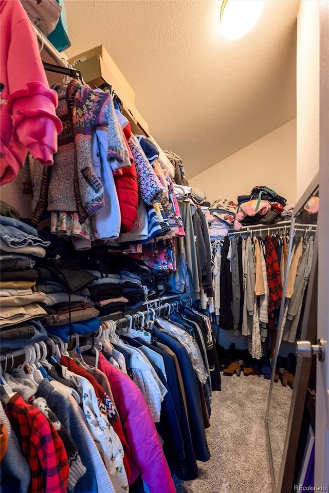 walk in closet with carpet