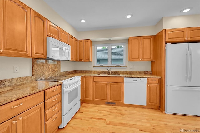 9930 W Progress Pl, Littleton, CO 80123 - kitchen featuring white appliances, light wood-type flooring, light stone counters, recessed lighting, and brown cabinets