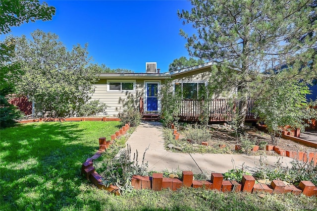 view of front facade with a front lawn and a wooden deck