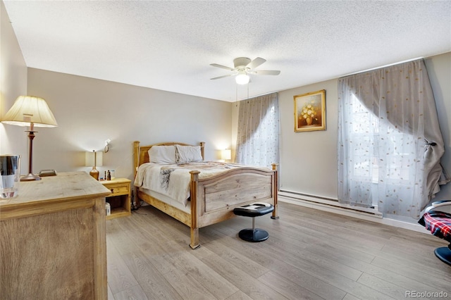 bedroom featuring a baseboard radiator, a textured ceiling, light wood-type flooring, and ceiling fan