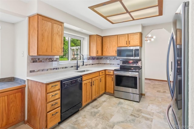 7681 S Jellison St, Littleton, CO 80127 - kitchen featuring stainless steel appliances, decorative backsplash, light countertops, and stone finish floors