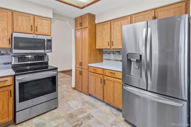 7681 S Jellison St, Littleton, CO 80127 - kitchen featuring stainless steel appliances, light countertops, and decorative backsplash