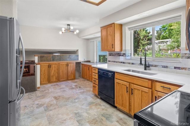 7681 S Jellison St, Littleton, CO 80127 - kitchen with freestanding refrigerator, dishwasher, electric stove, tasteful backsplash, and a chandelier