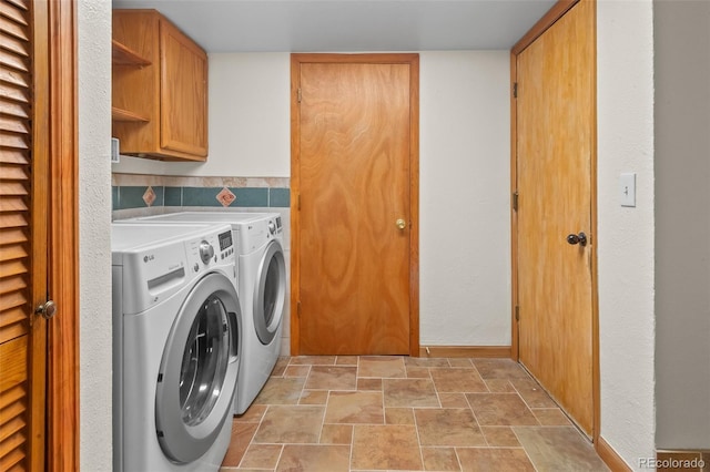 7681 S Jellison St, Littleton, CO 80127 - laundry room featuring cabinet space, washer and clothes dryer, and stone finish floors