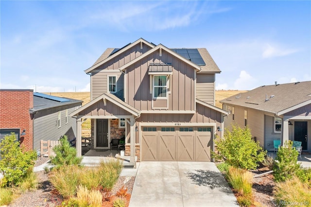 view of front facade featuring solar panels and a garage