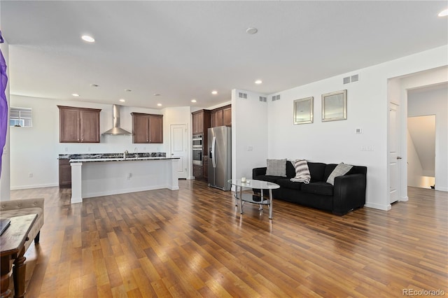 living room featuring sink and dark hardwood / wood-style flooring