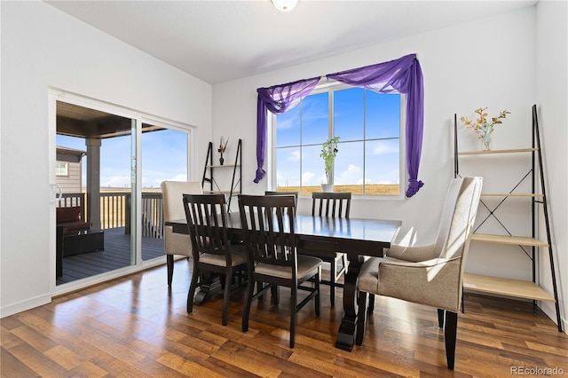 dining space with wood-type flooring and a wealth of natural light