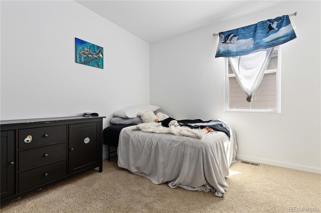 bedroom featuring light colored carpet