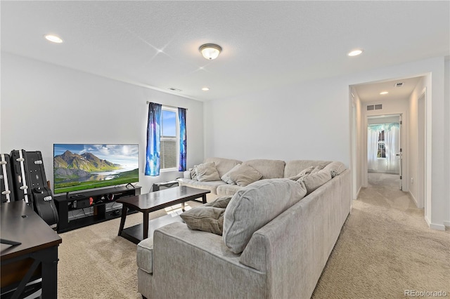 living room featuring light carpet and a textured ceiling