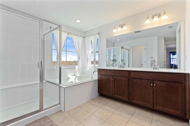 bathroom with tile patterned floors, vanity, and separate shower and tub