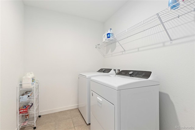 laundry room featuring separate washer and dryer and light tile patterned flooring