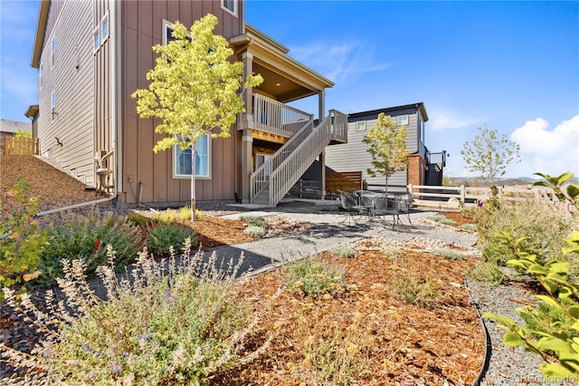 exterior space with a wooden deck and a patio