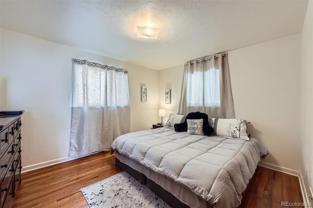 bedroom with hardwood / wood-style flooring