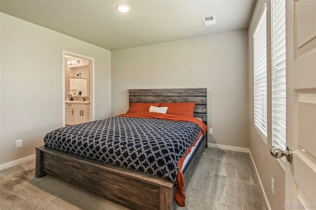 719 S Hoover Ave, Fort Lupton, CO 80621 - carpeted bedroom featuring baseboards and ensuite bathroom