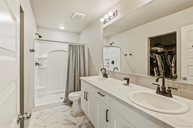 719 S Hoover Ave, Fort Lupton, CO 80621 - full bathroom featuring a shower stall, marble finish floors, toilet, and double vanity