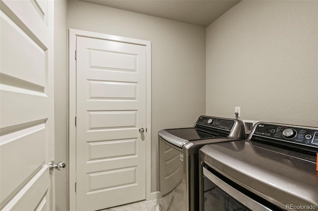 719 S Hoover Ave, Fort Lupton, CO 80621 - laundry room featuring separate washer and dryer and light marble finish floors