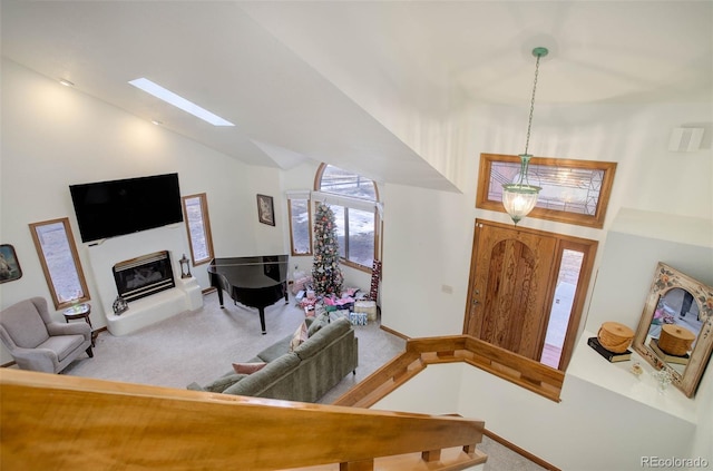 carpeted entryway featuring lofted ceiling