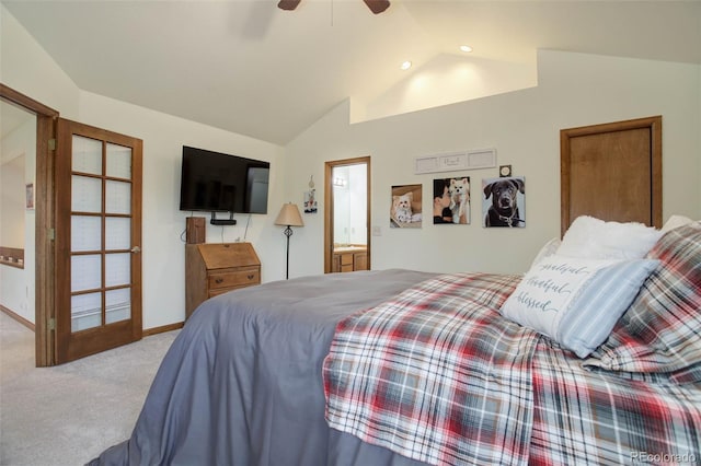 bedroom featuring connected bathroom, light colored carpet, ceiling fan, and lofted ceiling