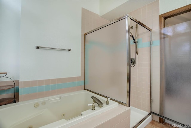 bathroom featuring separate shower and tub