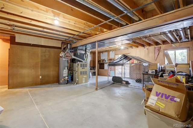 basement featuring heating unit and water heater