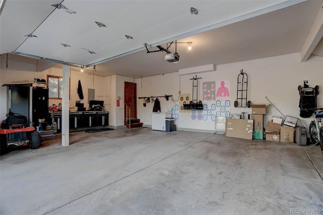 garage with a workshop area and a garage door opener