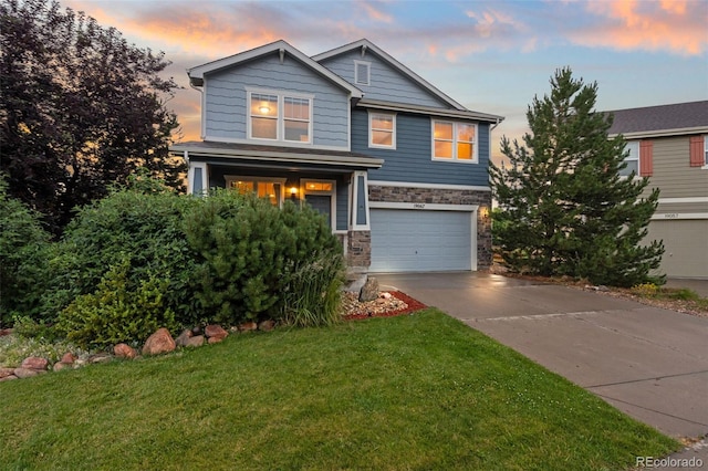19067 W 57th Dr, Golden, CO 80403 - craftsman-style house featuring an attached garage, stone siding, concrete driveway, and a front yard