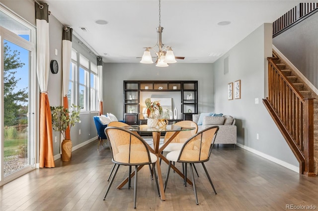 19067 W 57th Dr, Golden, CO 80403 - dining space with hardwood / wood-style flooring, a chandelier, and stairs