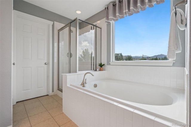 19067 W 57th Dr, Golden, CO 80403 - full bathroom with a garden tub, a shower stall, tile patterned flooring, and a mountain view