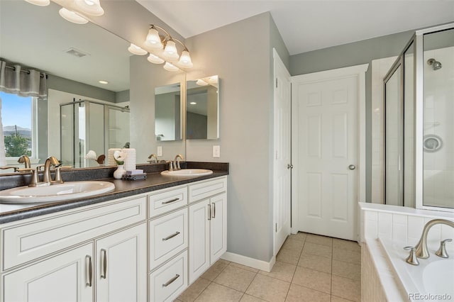 19067 W 57th Dr, Golden, CO 80403 - bathroom with double vanity, a shower stall, tile patterned flooring, and a garden tub