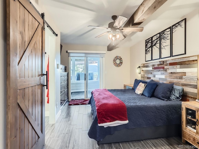 7273 Silverhorn Dr, Evergreen, CO 80439 - bedroom with a barn door, access to exterior, wood finished floors, and ceiling fan