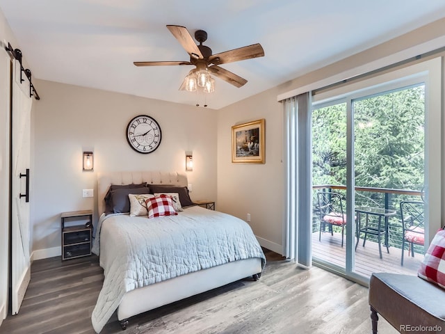7273 Silverhorn Dr, Evergreen, CO 80439 - bedroom with access to outside, wood finished floors, baseboards, and a barn door