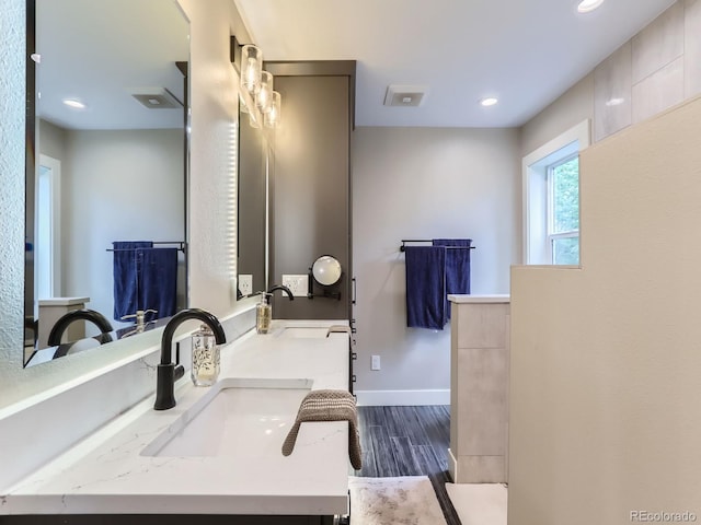 7273 Silverhorn Dr, Evergreen, CO 80439 - bathroom featuring wood finished floors, double vanity, baseboards, and recessed lighting