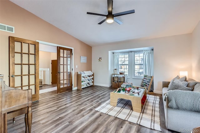 living room with french doors, ceiling fan, lofted ceiling, and wood-type flooring