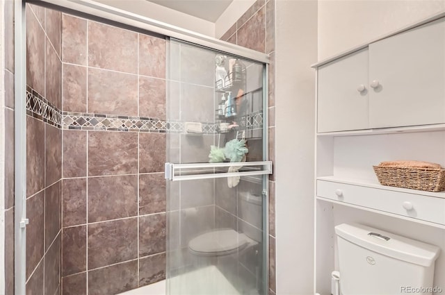 bathroom featuring an enclosed shower and toilet