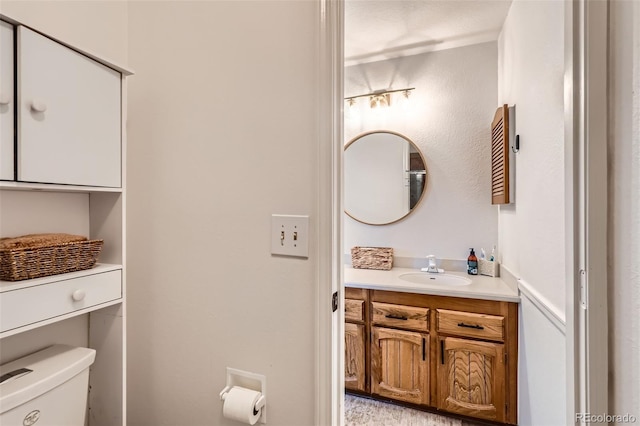 bathroom featuring vanity and toilet