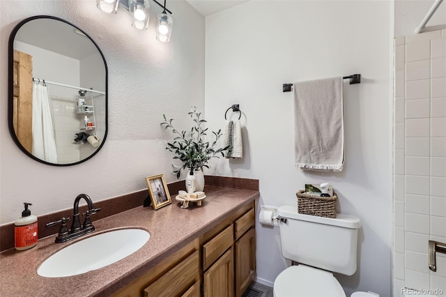 bathroom with vanity, toilet, and a shower with shower curtain