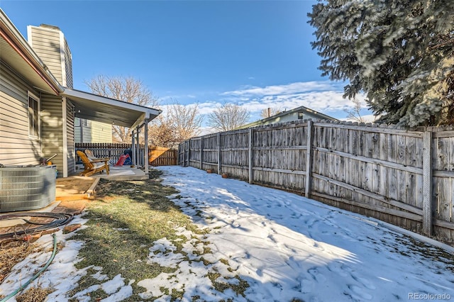 yard covered in snow featuring central AC