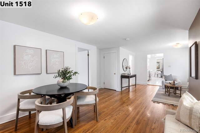 dining room with baseboards and light wood finished floors
