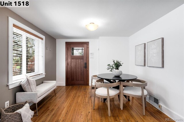 dining area featuring visible vents, baseboards, and light wood-type flooring