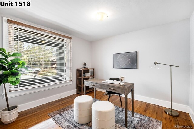 office area featuring baseboards and wood finished floors