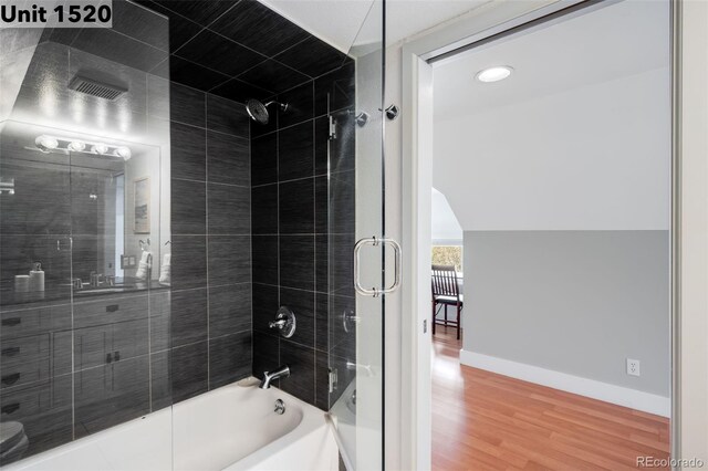 full bathroom with baseboards, shower / bathing tub combination, and wood finished floors