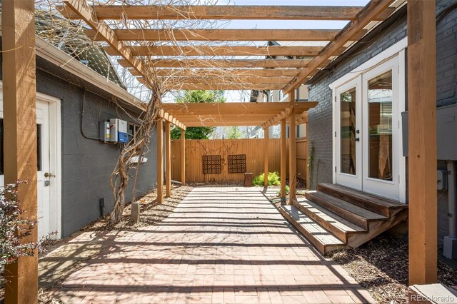 view of patio / terrace with french doors, fence, a pergola, and entry steps