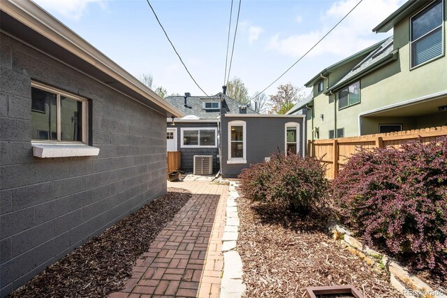 view of yard with fence and central AC