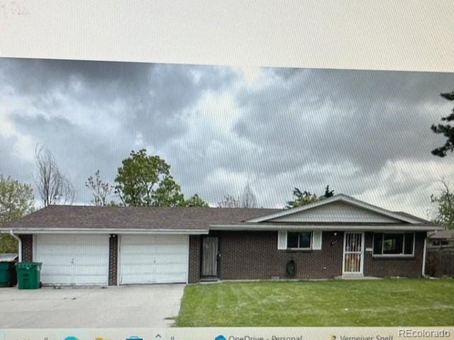 ranch-style home with a garage and a front lawn