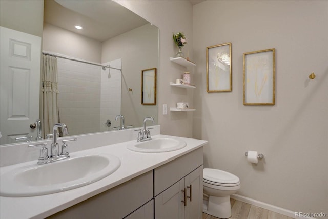 2785 Black Hawk Pl, Brighton, CO 80601 - bathroom featuring toilet, a shower with shower curtain, double vanity, wood finished floors, and baseboards